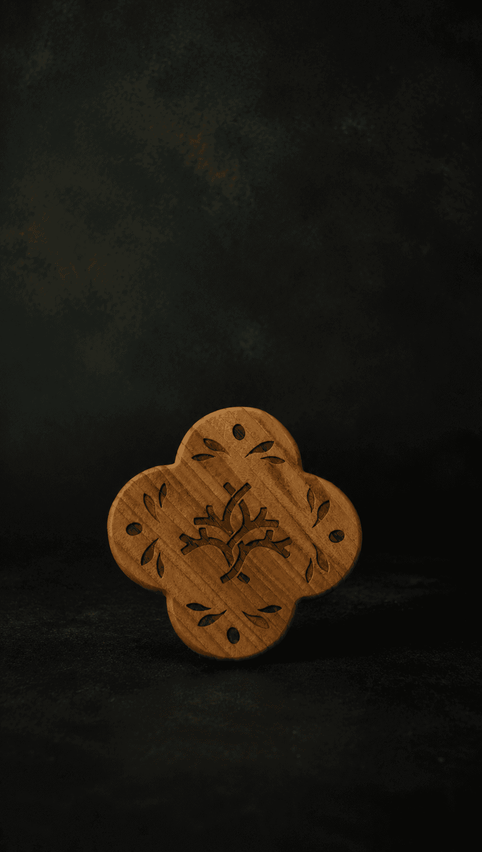 The quatrefoil coaster carved from Lebanese cedar on a near-black ground
